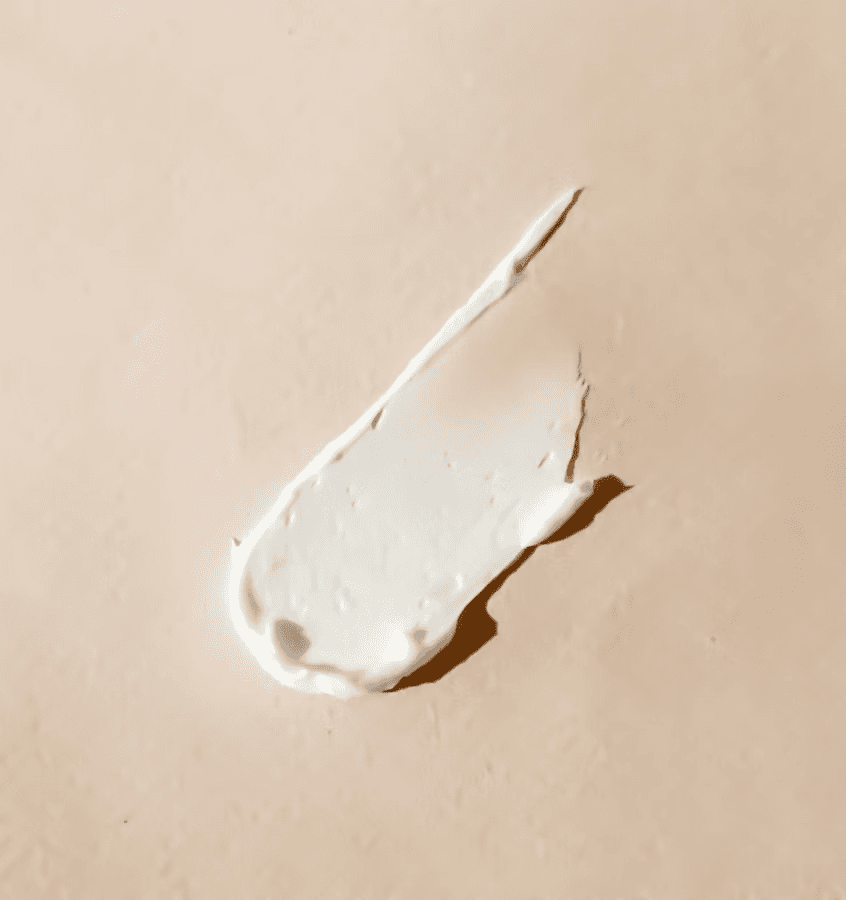 A smear of white cream on a tan surface
