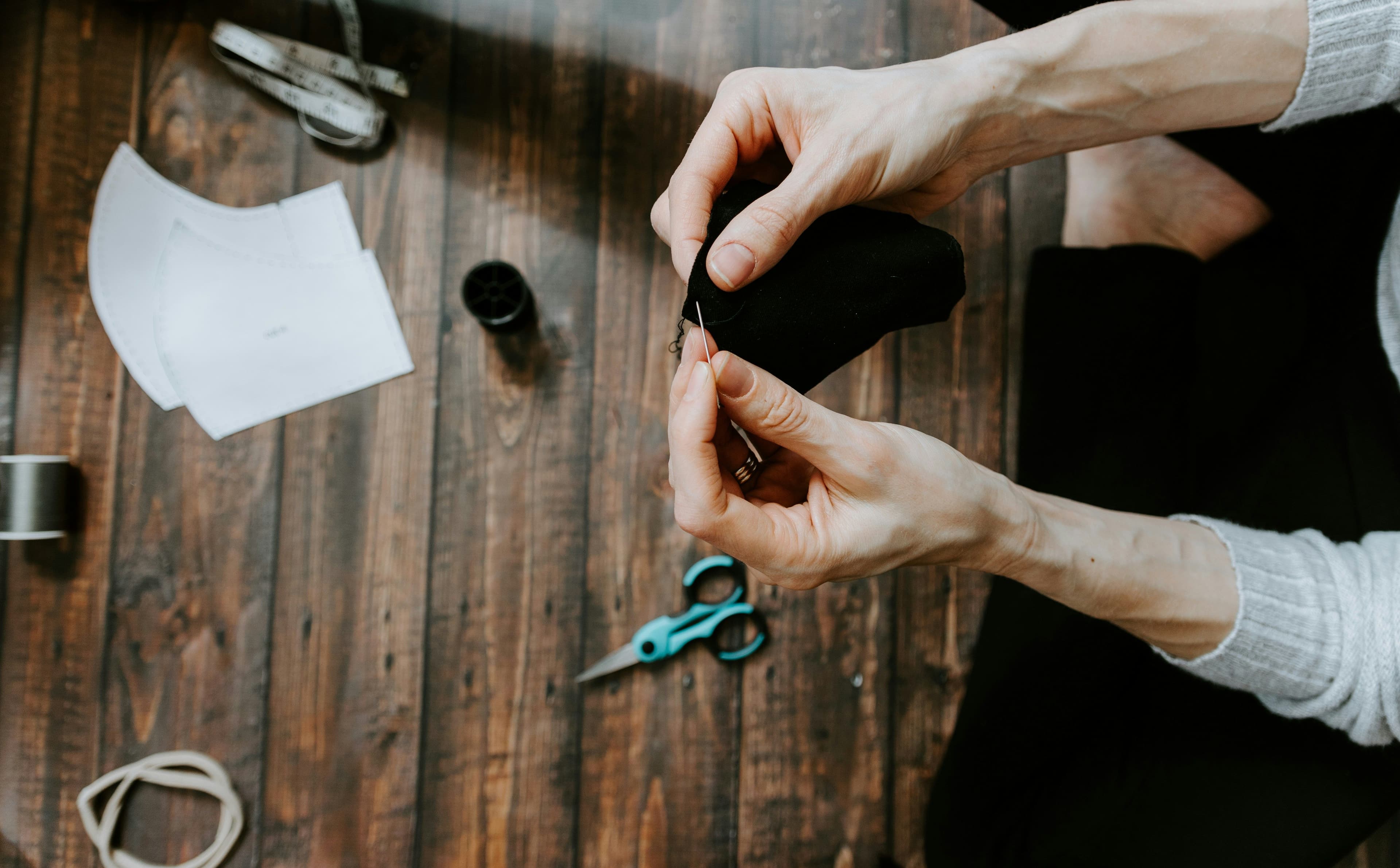 A person sewing a cloth